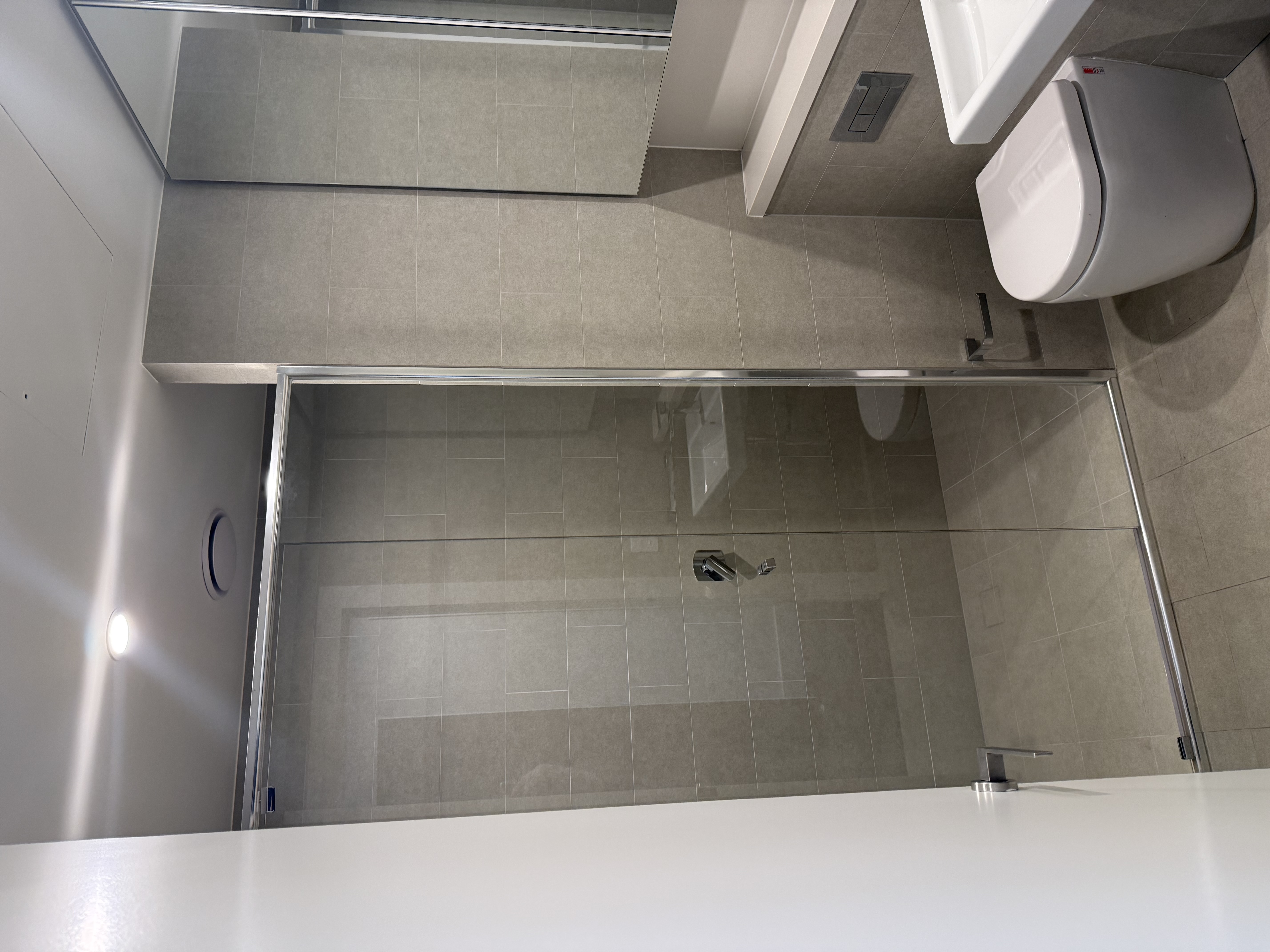 Tiled bathroom with glass shower