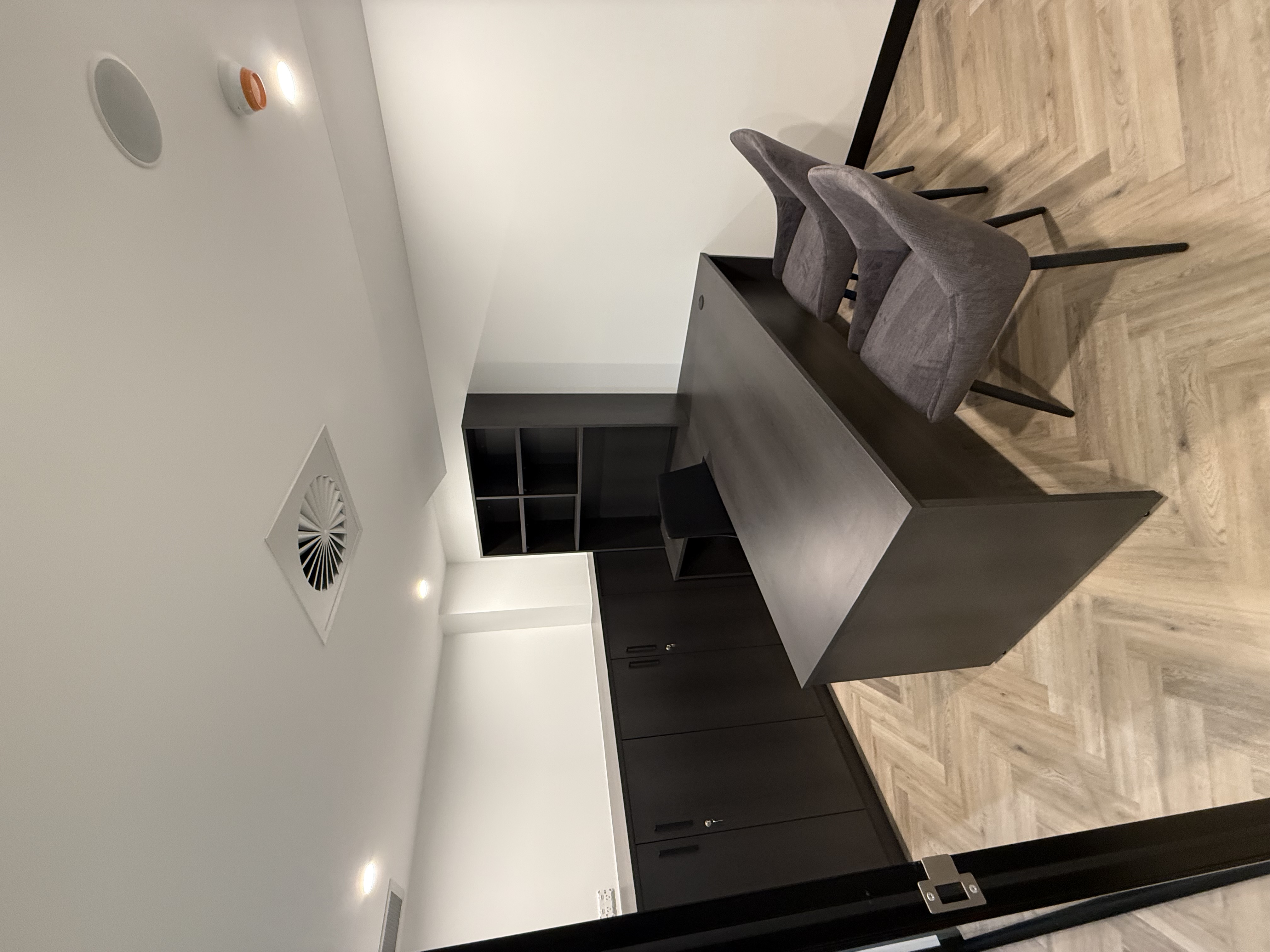 Clean office with dark cabinetry and desk